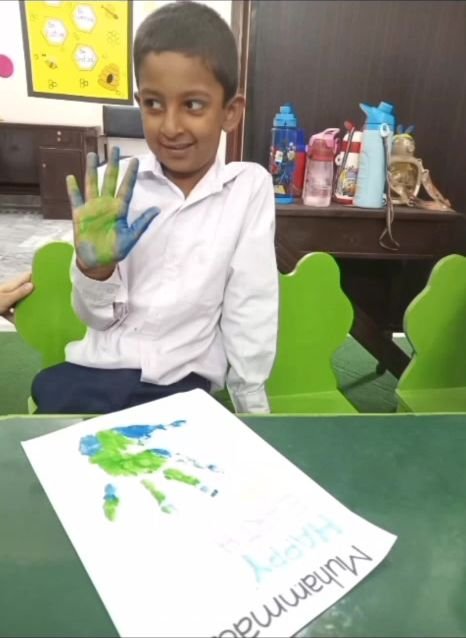 Student showing painted hand during the Earth Day activity