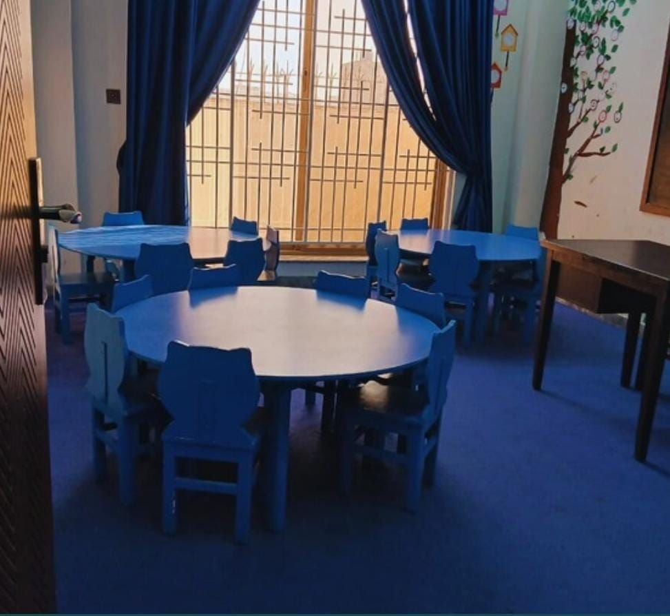 Classroom with blue round tables and chairs